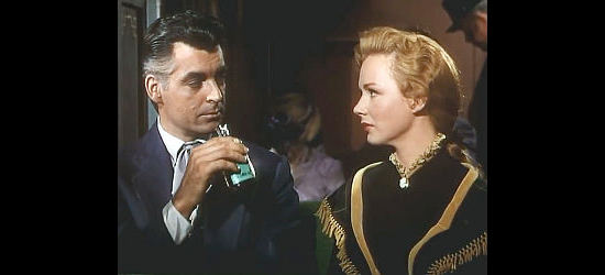 Rory Calhoun as Brett Wade and Piper Laurie as Rannah Hayes meet on a train in Dawn at Socorro (1954)