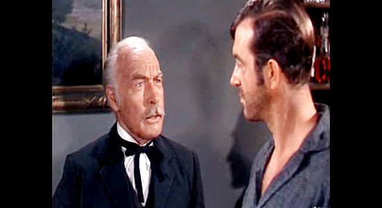 Roy Gordon as Dr. Colfax, trying to convince Rock Grayson to help residents of Galeston stand up to Roger Hale in The Vanquished (1953)