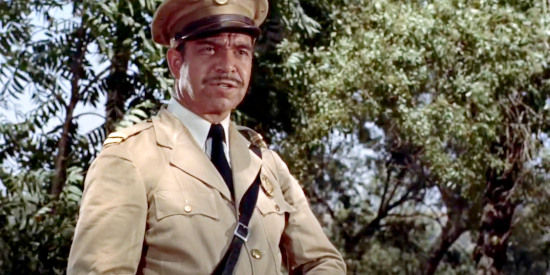 Salvador Baguez as Capt. Gonzelez, investigating a murder in The Americano (1955)