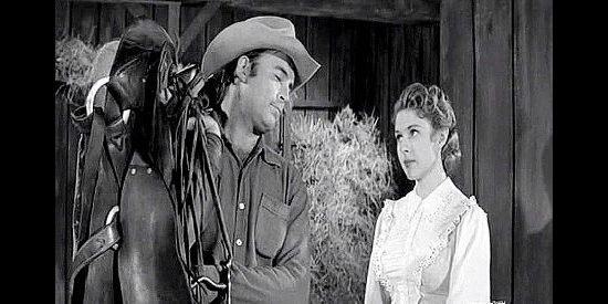 Scott Brady as Bart Jones and Mala Powers as Tay Rorick, sparring in The Storm Rider (1957)