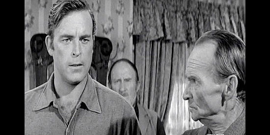 Scott Brady as Bart Jones, outlining a plan to best Bonnard while Capt. Cruickshank (William Fawcett) looks on in The Storm Rider (1957)