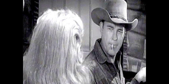 Scott Brady as Dan Kree, listening to Bess's offer to help her get back to the valley in Blood Arrow (1958)