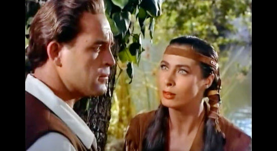 Scott Brady as Jonathan Adams, being warned of pending trouble by Onida (Rita Gam) in Mohawk (1956)