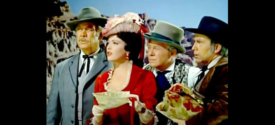 Stage passengers Sen. Blakely (Ward Bond), Amy Clarke (Linda Darnell), Minstrel (Regis Toomey) and Mark Chester (Whit Bissell) learn their shotgun guard is a wanted man in Dakota Incident (1956)