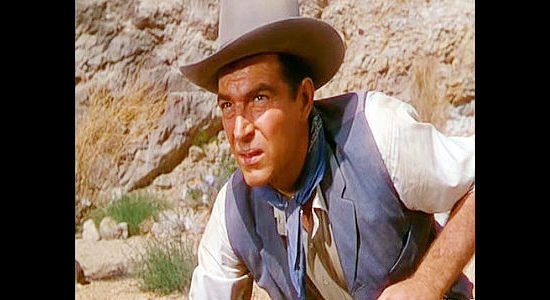 Stephen McNally as Sam Leeds, watching for Indians after coming upon the scene of a massacre in Apache Drums (1951)