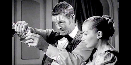 Sterling Hayden as John Garth, forcing new wife Valerie (Anita Eckberg) to down drink after drink in Valerie (1957)