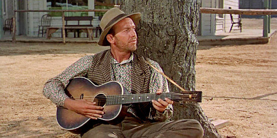 Terry Gilkyson as the balladeer who sings the Ballad of Sam Hall as the drama plays out around him in Star in the Dust (1956)