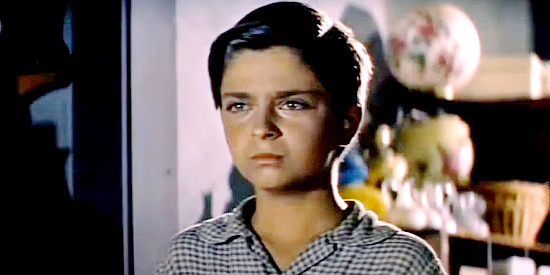 Tommy Rettig as Billy Wright, worried about his dad's safety as rumors swirl around Plainview in At Gunpoint (1955)