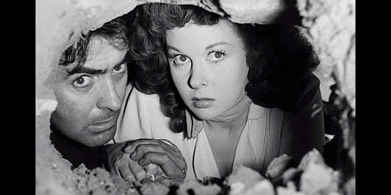 Tyrone Power as Tom Owens and Susan Hayward as Vinnie Holt, trying to dig their way out of trouble in Rawhide (1951)