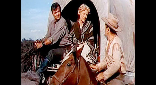 Wagon master Jeff Curtis (Rod Cameron) checking on Arch Lawrence (Noah Beery Jr.) and his pregnant wife (Anne Kimbell) in Wagons West (1952)