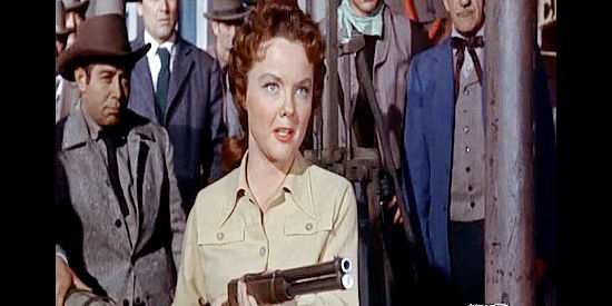 Wanda Hendrix as Ruth Lawrence, making a point with her rifle after her dad's death in The Black Dakotas (1954)