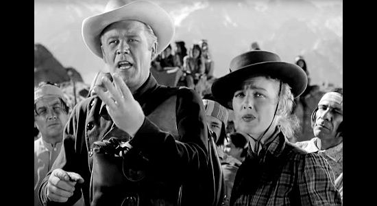Wayne Morris as Ford Smith and Virginia Grey as Mary Smith, trying to explain the plight they're facing to an Indian leader in Desert Pursuit (1952)