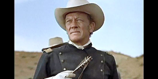 William Talman as Capt. Harper, holding a Ute arrow recovered from a dead cavalryman in Smoke Signal. (1955)