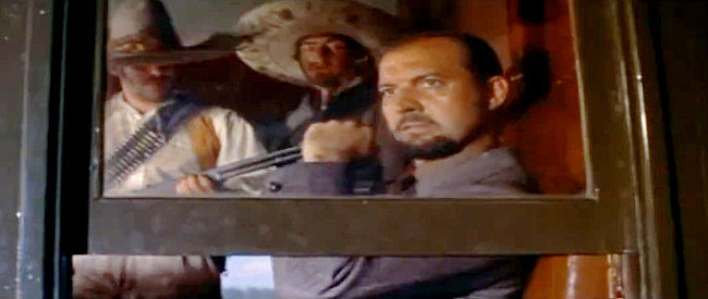 Zachary Scott as Kennedy, a gun-runner in danger of losing his weapons and his wife in Bandido! (1956)