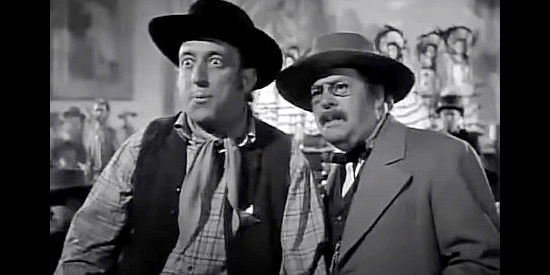 Allen Jenkins as Deputy Hank and Jed Prouty as Judge Harmon, watching Killer Pete storm in the saloon in Go West Young Lady (1941)