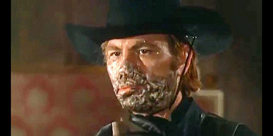 Angelo Boscariol as Black Bart, revealing why he walks around masked in El Rojo (1966)