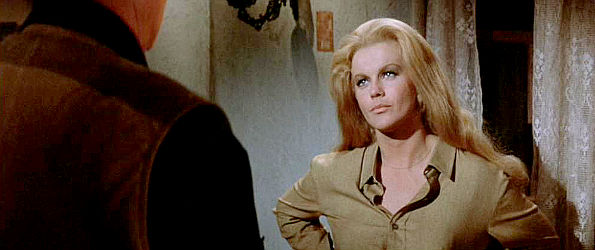 Ann-Margret as Mrs. Lowe, listening to Lane's warning about the dangers of the trip ahead in The Train Robbers (1973)