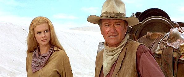 Ann-Margret as Mrs. Lowe with Lane (John Wayne) as he spots potential trouble on the horizon in The Train Robbers (1973)