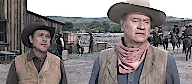 Ben Johnson as James Pepper and John Wayne as John Chisum, spotting a potential problem in Chisum (1970)