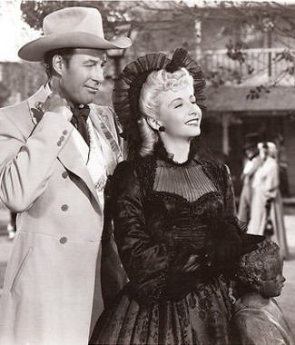 Bill Elliott as Charles Alderson and Vera Ralson at Karen Alderson in Wyoming (1947)
