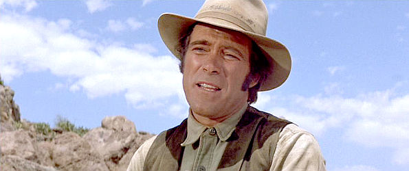Christopher George as Calhoun, slowing earning Lane's respect in The Train Robbers (1973)