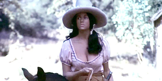 Ellyn Stern as Kana, riding into the ghost town where the Brock gang is staying in Jessi's Girls (1975)