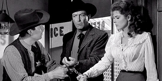 Fess Parker as Sheriff Weston, trying to disconnect Mackenzie Bovard (Robert Taylor) and Selah Jennison (Tina Louise) in The Hangman (1959)