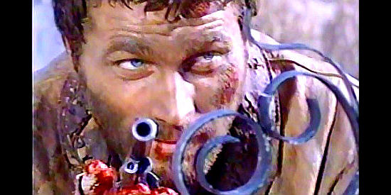 Franco Nero as Django, hands broken and bloodied, prepares for a final showdown in Django (1966)