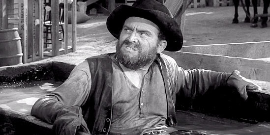 Gene Evans as Big Murphy, cooling off in a water trough with Johnny Bishop's help in The Hangman (1959)