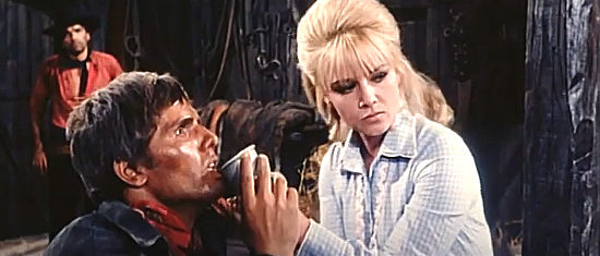 Giuliano Gemma (Montgomery Wood) as Gary Hammond gets a helping hand from Connie Breastfull (Sophie Daumier) after being tortured in Fort Yuma Gold (1966)