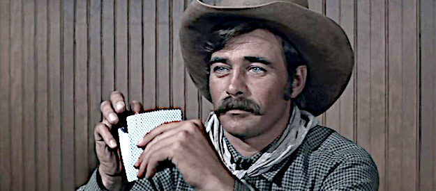 Glenn Corbett as Pat Garrett, playing a hand of poker that leads him to ride with John Chisum in Chisum (1970)