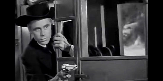 Glenn Ford as Tex Miller, defending the stagecoach from an Indian attack in Go West Young Lady (1941)