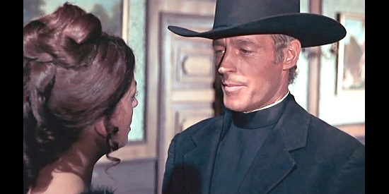 Guy Madison as Rev. Miller Colt, breaking the news that he's turned religious to a former saloon girl friend in Reverend Colt (1970)