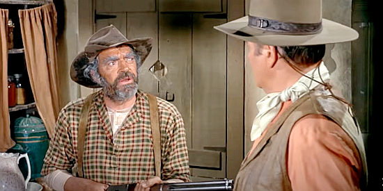 Jack Elam as Phillips, an eccentric with a trigger figure, with Cord McNally (John Wayne) in Rio Lobo (1970)