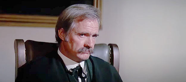 John Carter as the judge, presiding over Joe Kidd's hearing in Joe Kidd (1972)