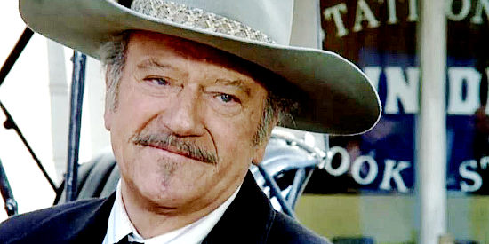 John Wayne as J.B. Brooks, an aging gunman dying of cancer in his final film, The Shootist (1976)