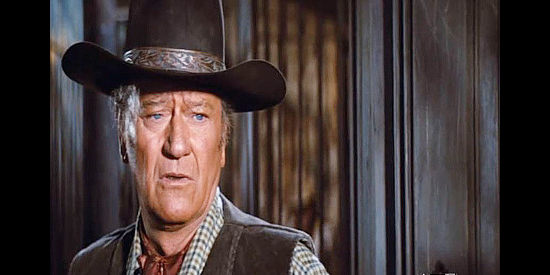 John Wayne as J.D. Cahill, learning the bank's been robbed and the sheriff killed when he was riding around chasing other bandits in Cahill U.S. Marshal (1973)