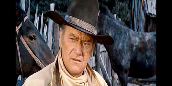 John Wayne as J.D. Cahill, trying to find a suitable horse to pursue the outlaws in Cahill U.S. Marshal (1973)