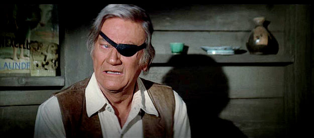 John Wayne as Rooster Cogburn, upset over losing his badge, at least temporarily, in Rooster Cogburn (1975)