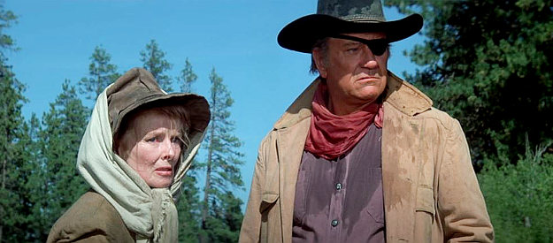 Katharine Hepburn as Eula Goodnight and John Wayne as Rooster Cogburn, facing stiff odds in a trip down the river in Rooster Cogburn (1975)