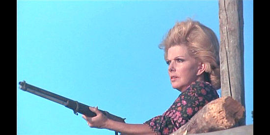 Maria Martin as Mary MacMurray, prepared to help defend the fort in Reverend Colt (1970)