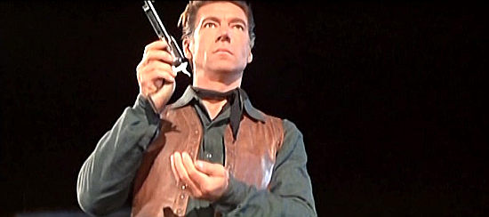 Mickey Hargitay as Ringo Carson, preparing for a bullet swap challenge with former friend Frank Sanders in Three Bullets for Ringo (1966)