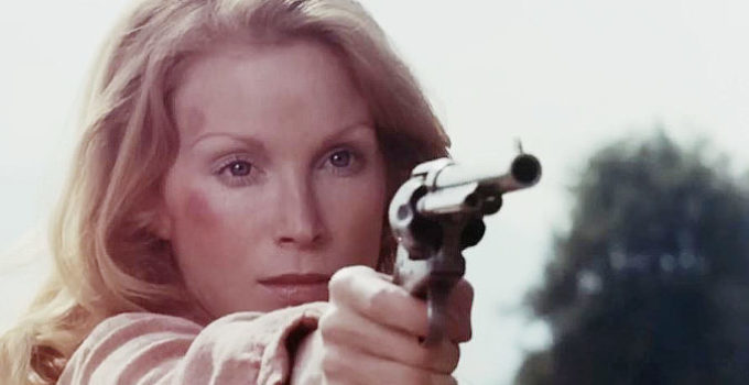 Sondra Currie as Jessi, honing her six-shooting skills for the mission ahead in Jessi's Girls (1975)
