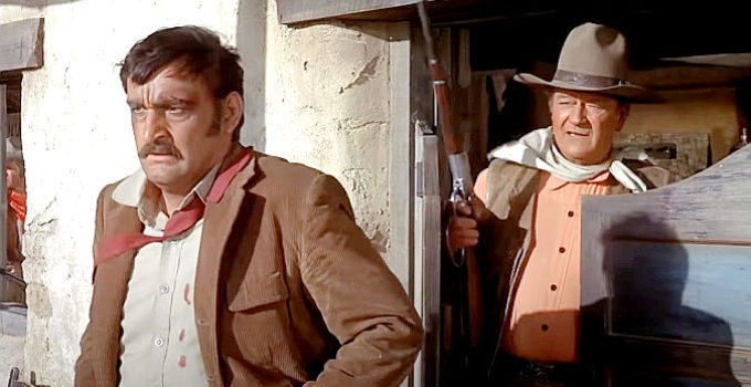 Victor French as Ketcham, under the gun of John Wayne as Cord McNally in Rio Lobo (1970)