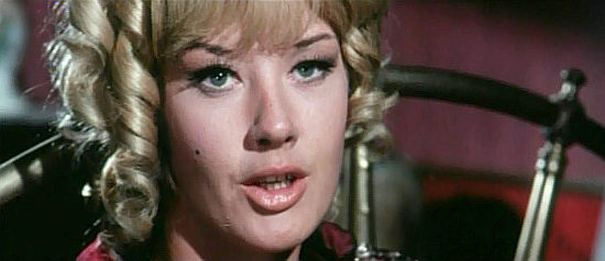 Pamela Tudor as Sabine, the saloon owner who takes a liking to Sam in One After Another (1968)
