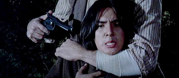 Richard Romancito as Wolf, Eula's young Indian friend, in the hands of Hawk's men in Rooster Cogburn (1975)