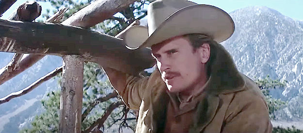 Robert Duvall as Frank Harlan, quizzing Helen Sanchez about Louis Chama's whereabouts in Joe Kidd (1972)