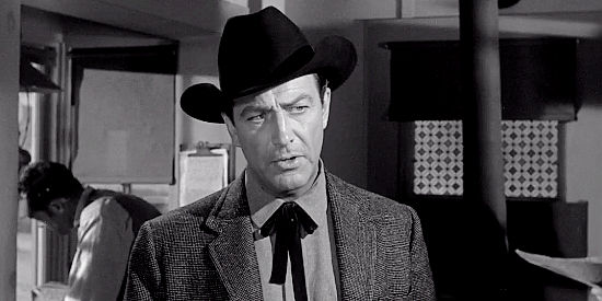 Robert Taylor as Mackenzie Bovard, fishing for informaation on a man named Butterfield in The Hangman (1959)