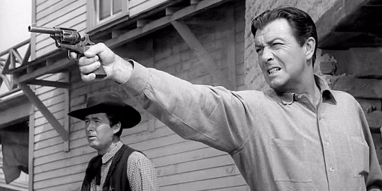 Robert Taylor as Mackenzie Bovard, taking aim at an escaping prisoner while Sheriff Weston (Fess Parker) looks on in The Hangman (1959)