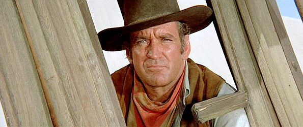 Rod Taylor as Grady, fretting about getting old and slowing down in The Train Robbers (1973)